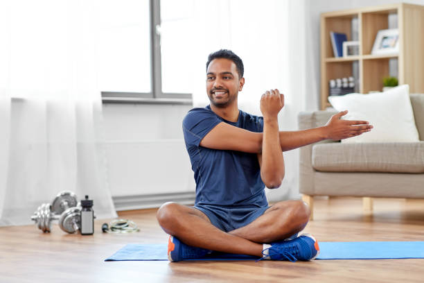 male estrogen blocker - a picture of a man smiling and stretching on a yoga mat