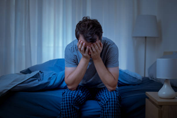 estrogen inhibitors - a man on the bed with his hands covering his face